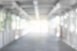 abstract blurred background outdoor walk way to shopping mall defocused depth white bokeh with customer walking in to hall of department store.