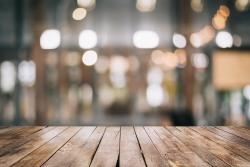 3D Rendering, Empty wooden table top with lights bokeh on blur restaurant background