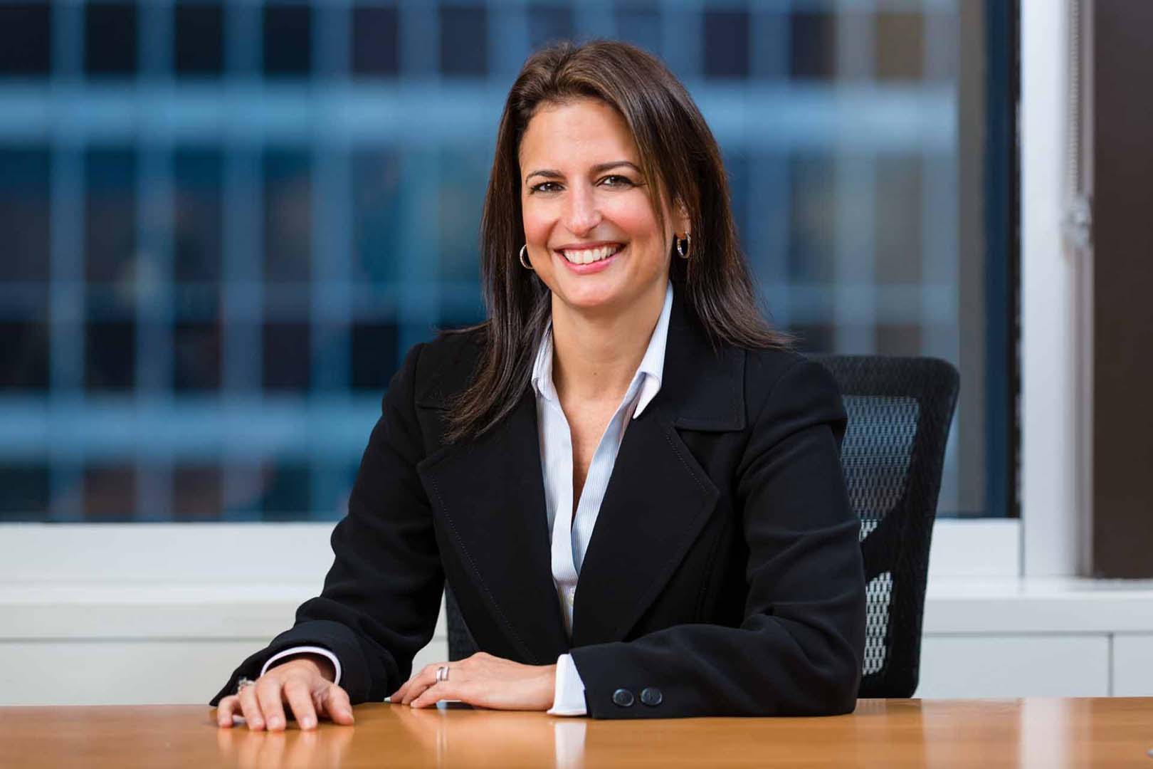 Financial-executive-sitting-at-her-desk Financial-executive-sitting-at-her-desk